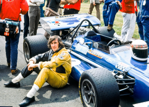 Jackie Stewart - Sat by Racing Car
